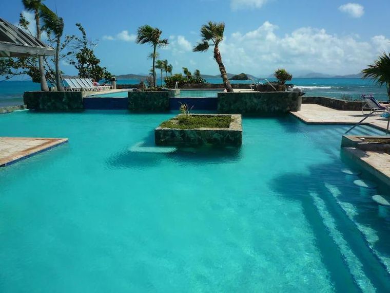 Cascading pool terrace a few steps from the door of this St. Thomas condo for couples and monthly rentals