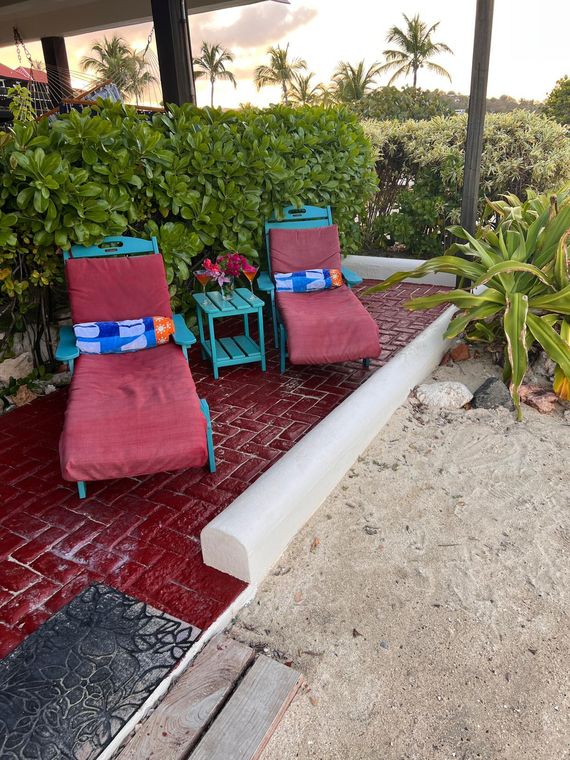 Beach lounge chairs on the path just outside the door of this St. Thomas condo with resort amenities