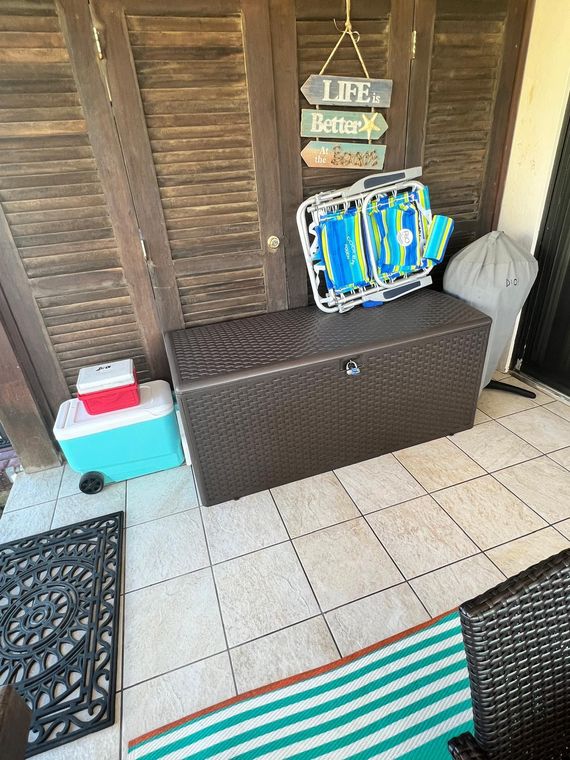 Patio storage bench with the beach chairs, floats and cooler provided at this St. Thomas rental during hurricane season